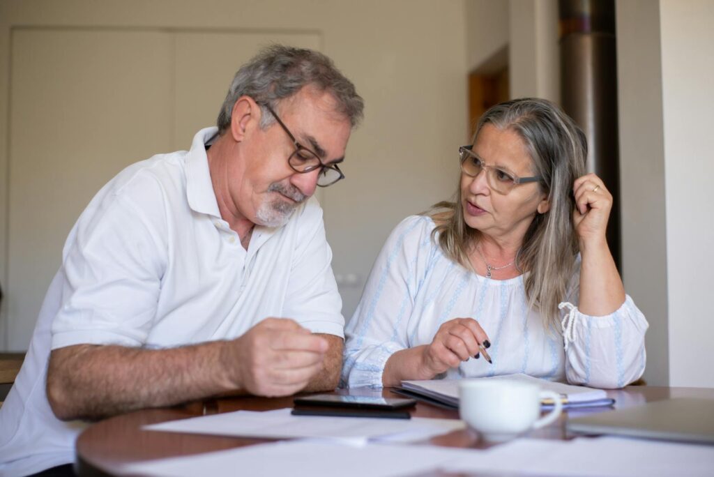 Elderly Couple Completing Documents